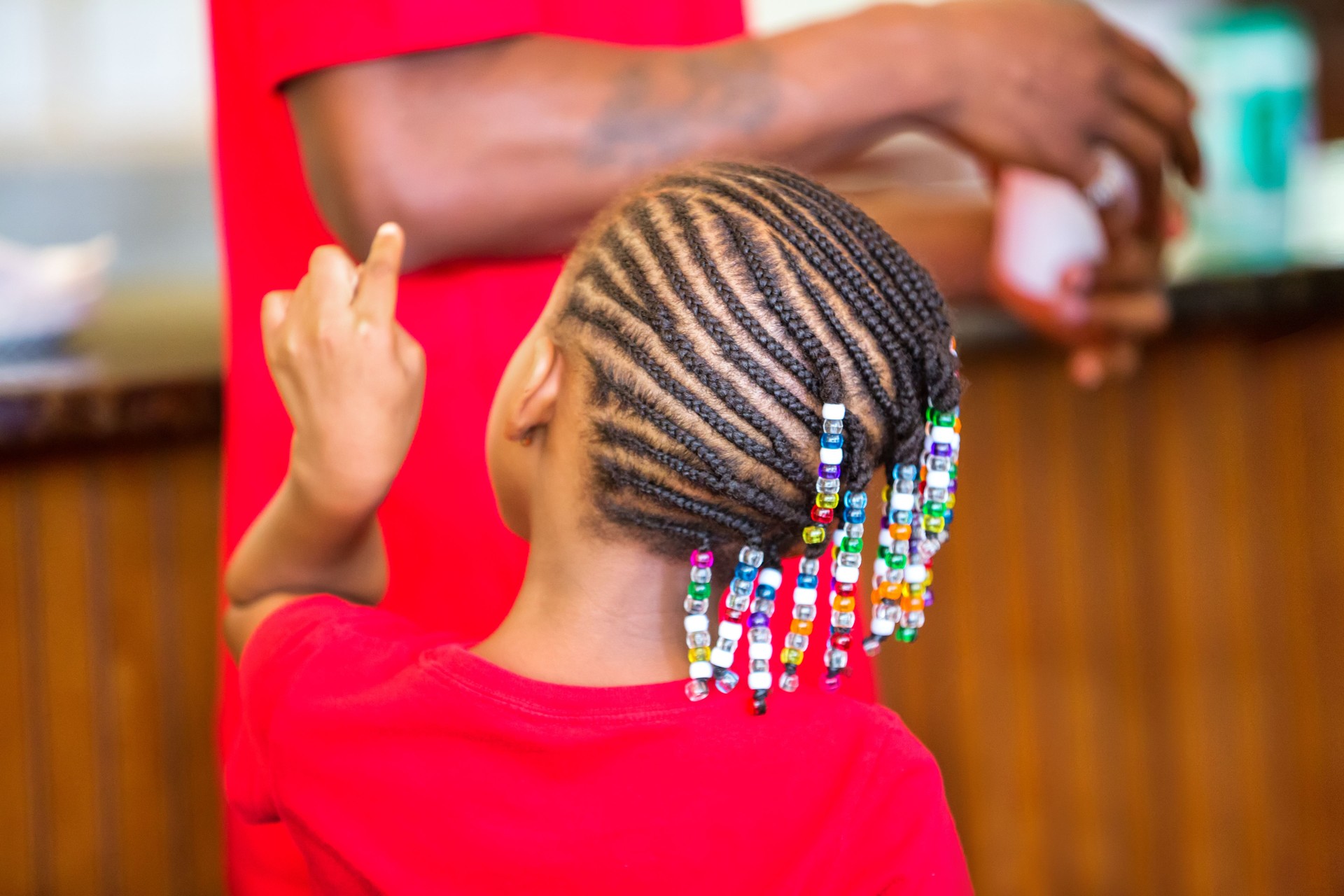 Rear view of young girl with corn rows